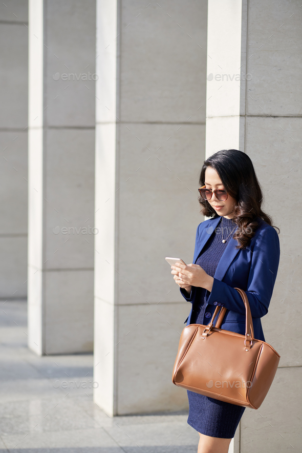 Asian Designer Using Smartphone - Stock Photo - Images