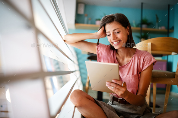 Portrait of cheerful woman using portable pc for blogging in social networks