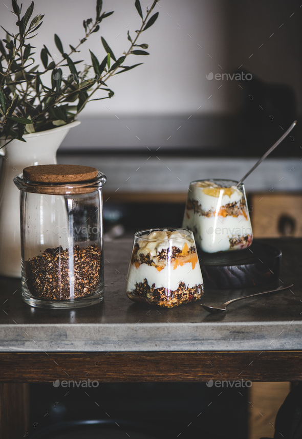 Healthy breakfast with yogurt, granola and fruits in glasses - Stock Photo - Images