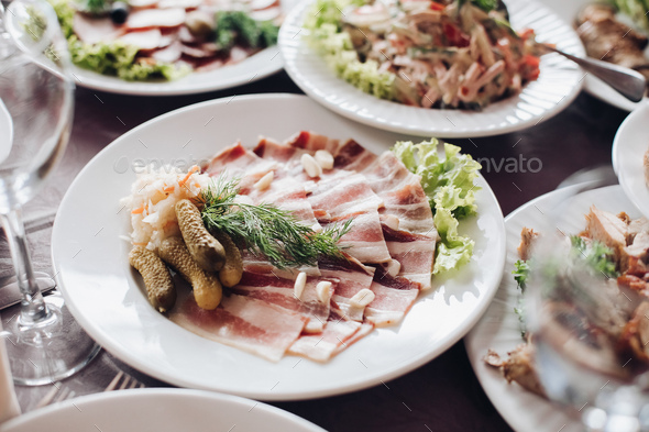 Banquet table served with various cold snacks and salads - Stock Photo - Images