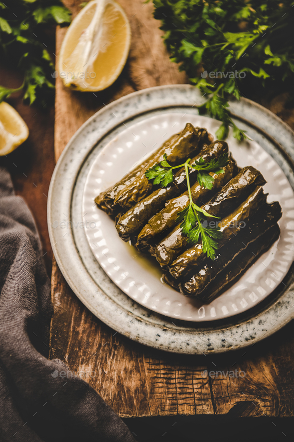 Turkish traditional Dolma with rice and spices over wooden background - Stock Photo - Images