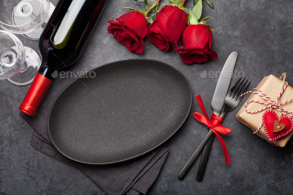 Valentines day with empty plate, gift, wine and roses - Stock Photo - Images