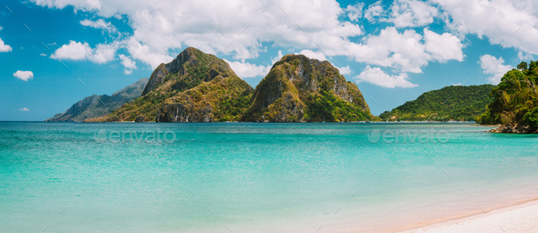El Nido, Corong Corong beach with massive limestone mountain ridge top with blue lagoon in front - Stock Photo - Images