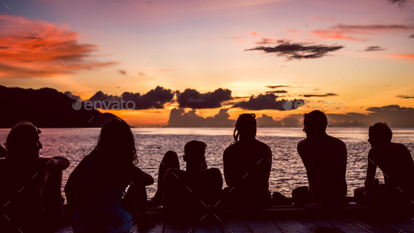 Travelers, Divers chilling at the Pier on Sunset, Kri Island. Raja Ampat, Indonesia, West Papua - Stock Photo - Images