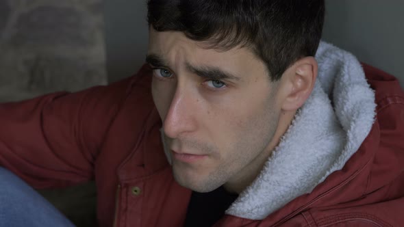 sad depressed young drug addict man looking at camera.Sad,depressed gaze alt