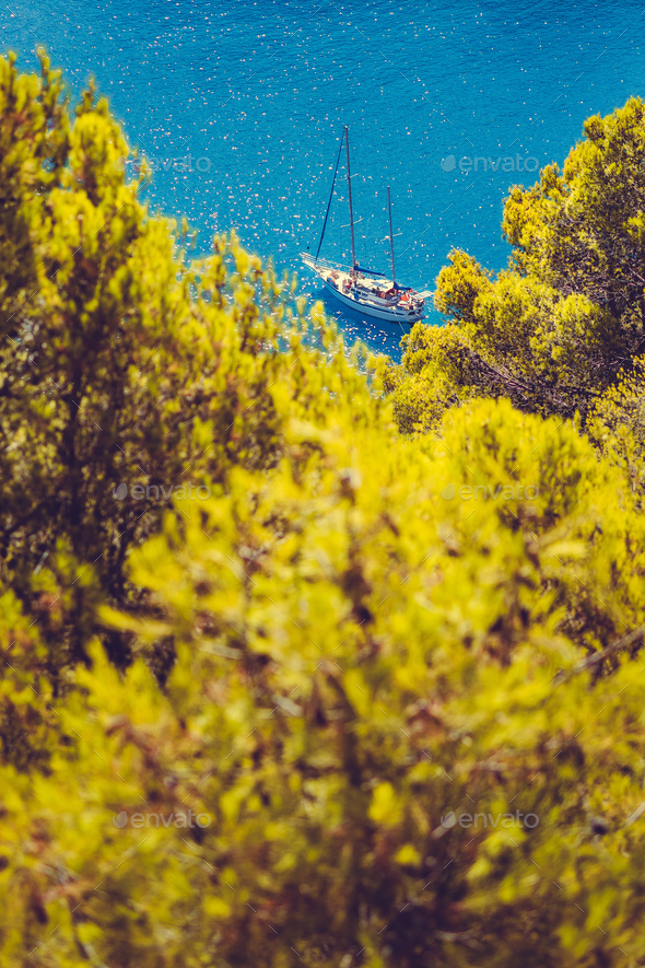 White yacht take a shelter in beautiful blue lagoon of Assos village Kefalonia. Frame between top of - Stock Photo - Images