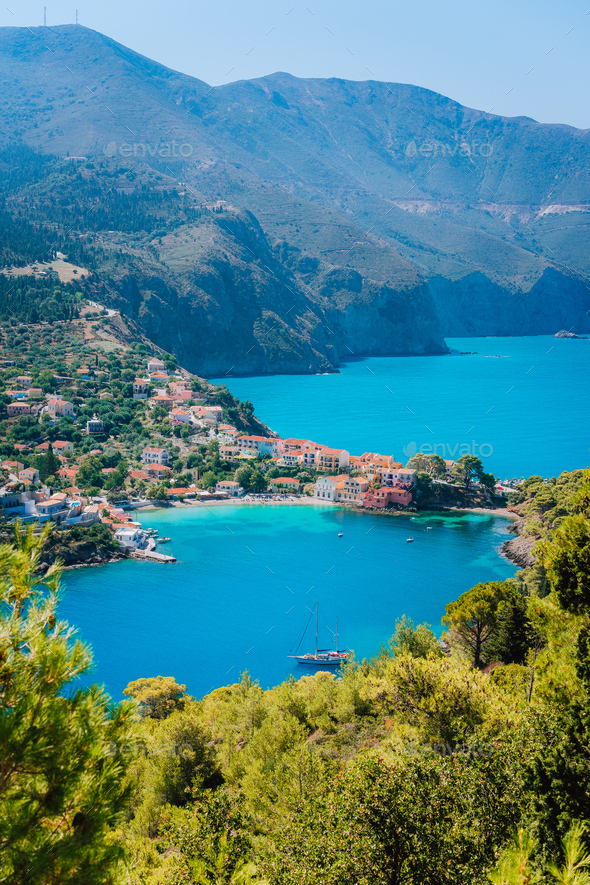Mediterranean seashore in Greece. Beautiful turquoise colored Assos bay water surrounded by pine and - Stock Photo - Images