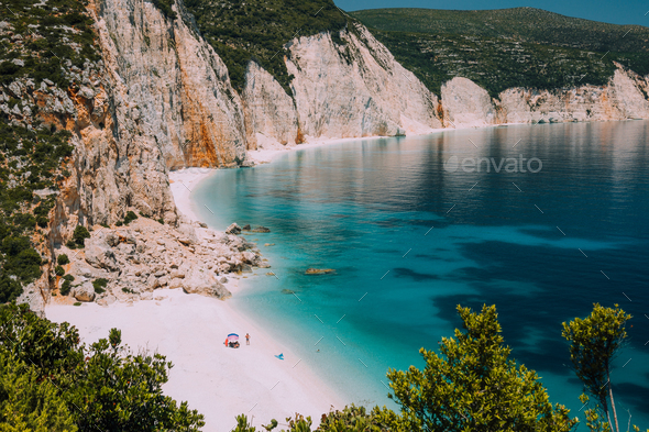 Fteri beach. Blue lagoon with rocky coastline, Kefalonia, Greece. Calm clear blue emerald green - Stock Photo - Images