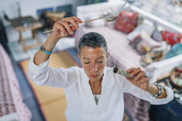 Smudging or Space Cleansing with Sage for Removal of Negative Energies, Spirituality and Health - Stock Photo - Images