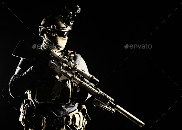 Army marksman with sniper rifle in darkness - Stock Photo - Images
