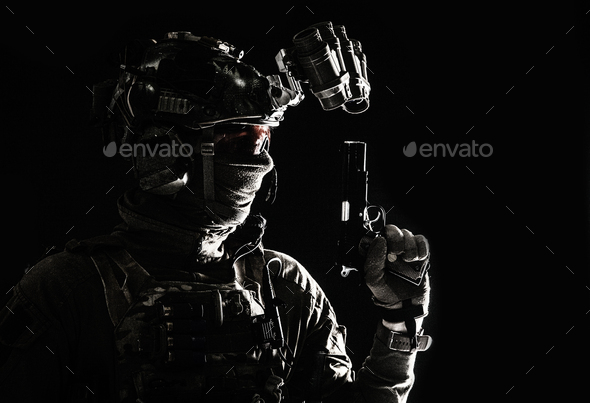 Combatant armed with service pistol in darkness - Stock Photo - Images