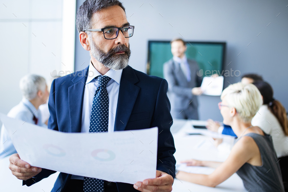 Successful team leader and business owner leading informal in-house business meeting - Stock Photo - Images