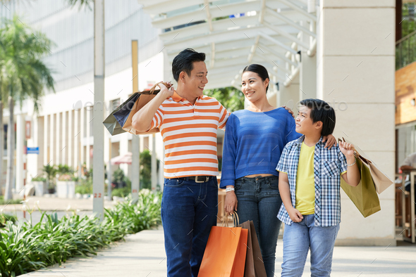 Asian Family with Shopping Bags - Stock Photo - Images
