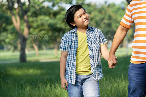 Enjoying Pleasant Walk with Loving Dad - Stock Photo - Images