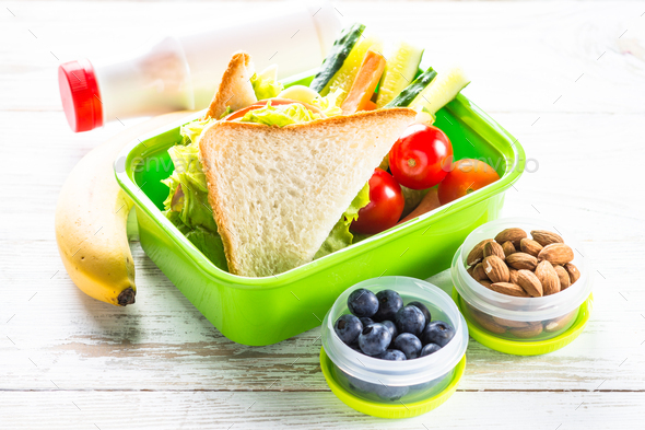 Lunch box with sandwich, vegetables, berries and nuts - Stock Photo - Images