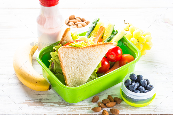 Lunch box with sandwich, vegetables, berries and nuts - Stock Photo - Images