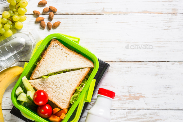 Lunch box with sandwich, vegetables, yogurt, nuts and berries - Stock Photo - Images