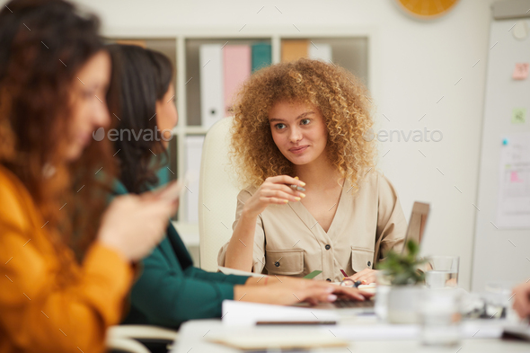 Female Colleagues Chatting During Meeting - Stock Photo - Images
