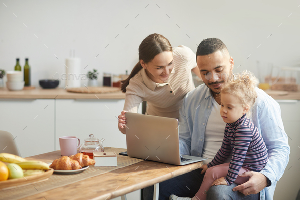 Modern Family Using Laptop with Cute Little Daughter
