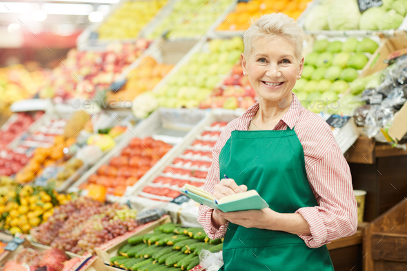 Female Shop Assistant at Farmers Market - Stock Photo - Images