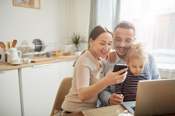 Modern Family Using Gadgets with Cute Little Girl - Stock Photo - Images
