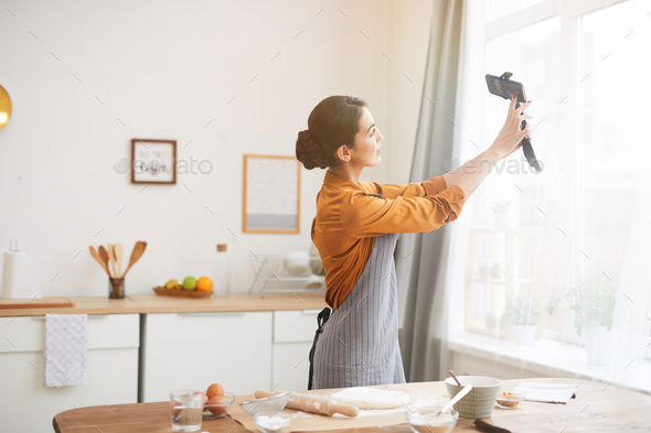 Young Woman Filming Vlog in Kitchen - Stock Photo - Images