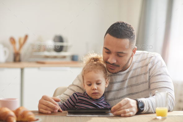 Modern Father Using Digital Tablet with Cute Little Girl - Stock Photo - Images