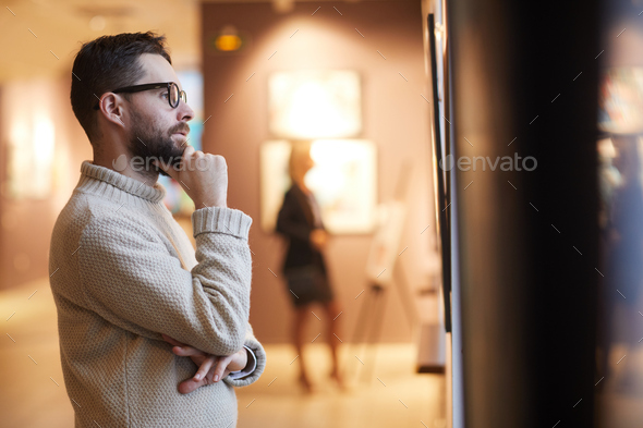 Bearded Man Looking at Paintings in Art Gallery - Stock Photo - Images