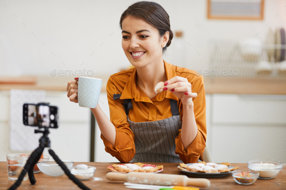 Young Woman Filming in Cozy kitchen - Stock Photo - Images