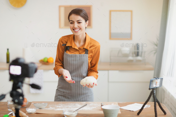 Smiling Woman Filming Baking Video - Stock Photo - Images