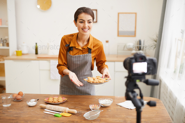 Young Woman Filming Baking Video in Kitchen - Stock Photo - Images