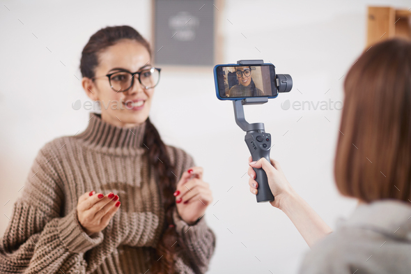 Smiling Woman Filming Video for Social Media Channel - Stock Photo - Images