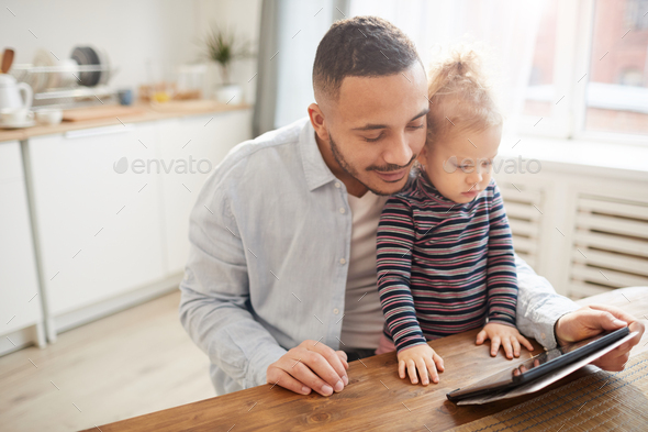 Caring Father Using Digital Tablet with Cute Little Girl - Stock Photo - Images