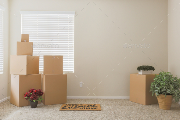 Variety of Packed Moving Boxes In Empty Room - Stock Photo - Images