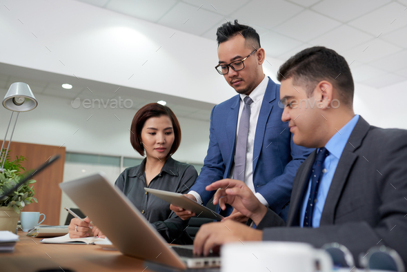 Analyzing Statistic Data with Coworkers - Stock Photo - Images