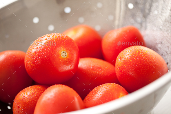 Fresh, Vibrant Roma Tomatoes in Colander with Water Drops - Stock Photo - Images