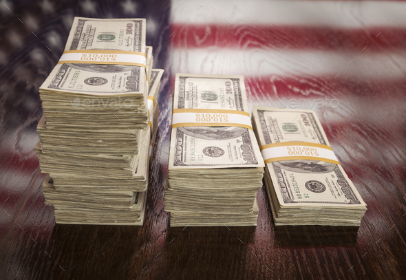 Thousands of Dollars with Reflection of American Flag on Table - Stock Photo - Images