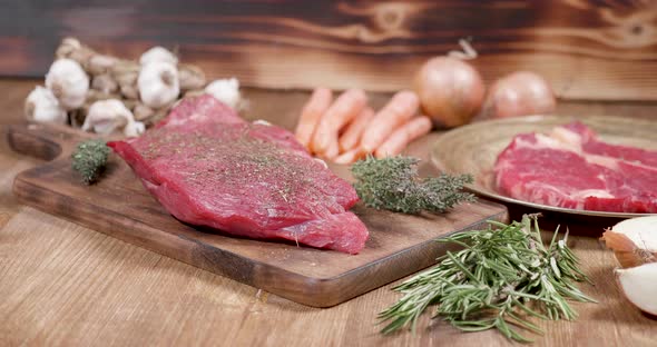 Fresh, Raw, Juicy Beef Steak on a Wooden Vintage Board alt