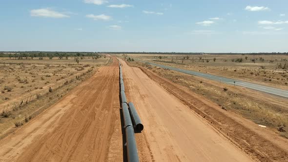 Rising above a pipeline being constructed in the Australian outback alt