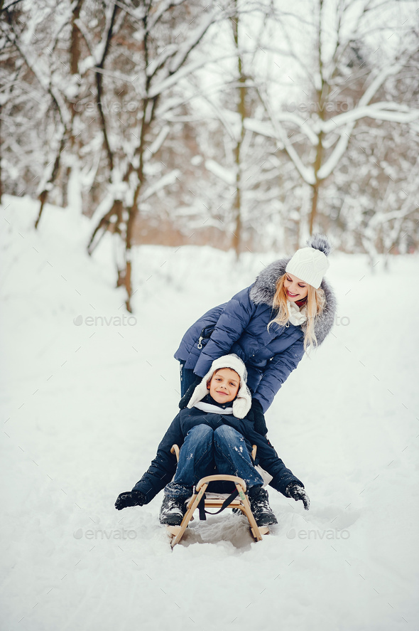 Mother with cute son in a winter oark