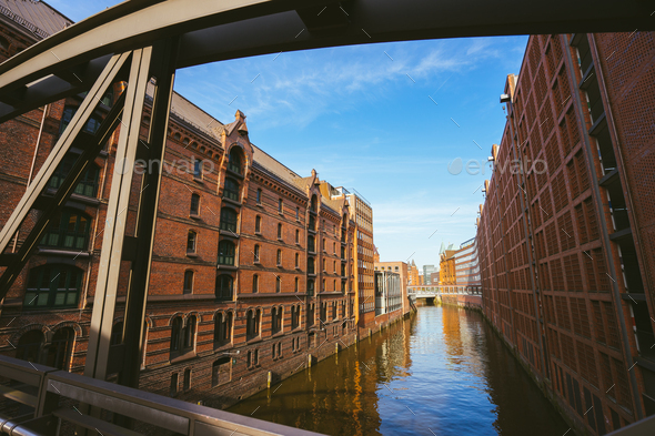 Famous landmark old Speicherstadt in Hamburg, build with red bricks. Bridge in low angle view - Stock Photo - Images