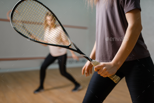 Two female players with rackets, squash game - Stock Photo - Images