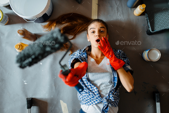 Female house painter lies on the floor, top view - Stock Photo - Images