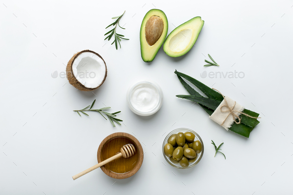 Golden honey in jar, coconut, avocado and aloe isolated on white - Stock Photo - Images