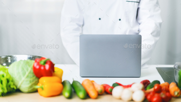 Unrecognizable Chef Man Using Laptop Writing Article In Kitchen, Panorama
