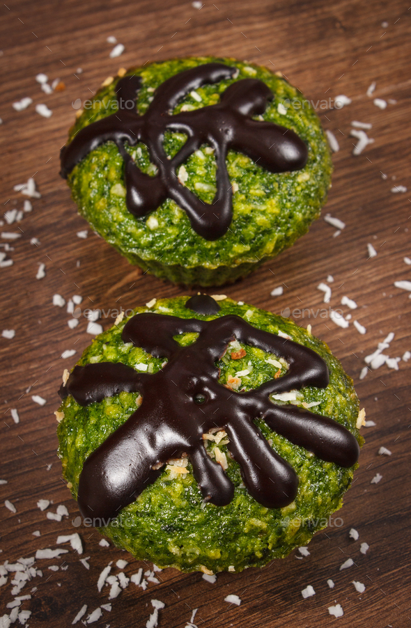 Fresh muffins with spinach, desiccated coconut and chocolate glaze, delicious healthy dessert - Stock Photo - Images