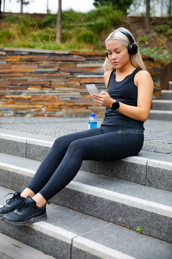 Sporty Young Woman Listening Music With Headphones And Smartphone - Stock Photo - Images
