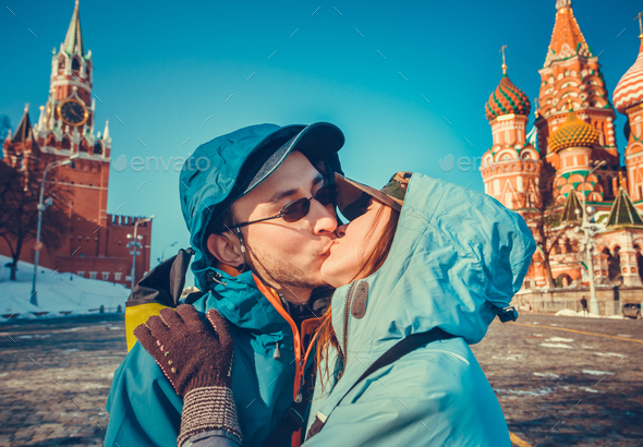 Happy tourists kissing on Red Square, Moscow - Stock Photo - Images