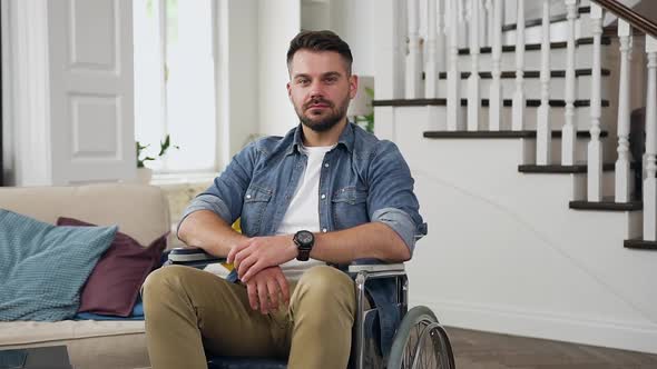 Sedentary Guy in Wheelchair Looking at Camera in Beautifully Designeted house alt