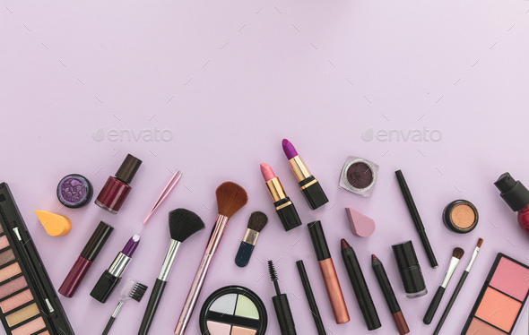 Make up cosmetics products against pastel purple background, Stock Photo by  rawf8